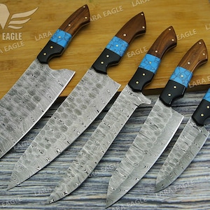 May include: Five kitchen knives with wooden handles and blue and black accents. The blades are made of patterned steel.