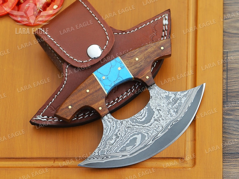 May include: A handmade Damascus steel throwing knife with a blue and brown handle. The knife is in a leather sheath.