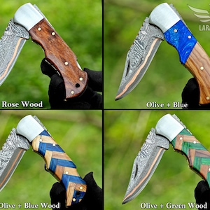 May include: Four folding knives with unique handle designs. One features rosewood, another olive and blue, a third olive and blue wood, and the last olive and green wood. Each knife has a patterned blade and silver accents. The Lara Eagle logo is visible.