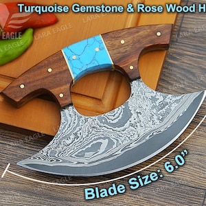 May include: A turquoise gemstone and rose wood handle cleaver with a 6.0 inch blade. The blade is made of Damascus steel and has a unique pattern.