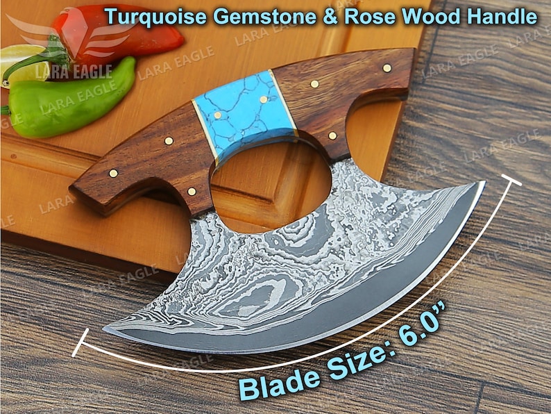 May include: A turquoise gemstone and rose wood handle cleaver with a 6.0 inch blade. The blade is made of Damascus steel and has a unique pattern.