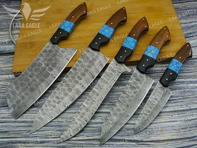 May include: Five kitchen knives with wooden handles and blue and black accents. The blades are made of patterned steel.