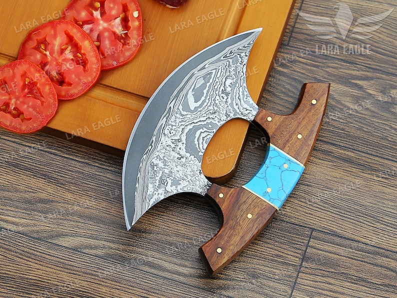 May include: A curved, stainless steel knife with a blue and brown wooden handle. The knife has a unique, patterned blade and is designed for chopping and slicing.