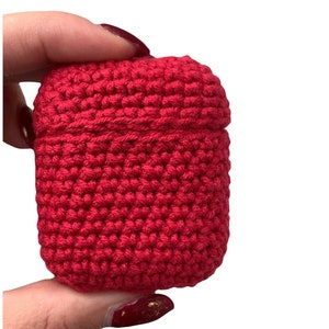 May include: A bright red crocheted case for a pair of wireless earbuds.