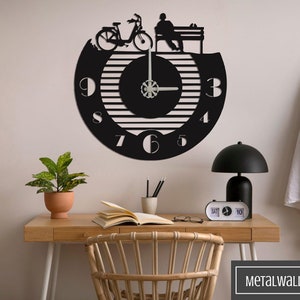 May include: Black metal wall clock with a striped design and a silhouette of a person sitting on a bench with a bicycle. The clock has Roman numeral markings and a white background.