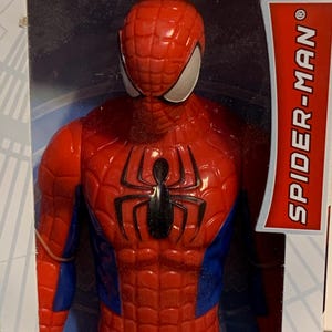 May include: A red and blue Spider-Man action figure with a black spider logo on the chest. The figure is packaged in a white box with the words "SPIDER-MAN" in red.