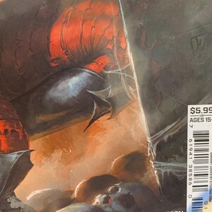 May include: Comic book cover featuring a dark, detailed illustration with a red and black color scheme. The artwork depicts a creature with sharp features and a skull. The cover includes the price, age range, and the names Thompson, Sherman, and Bellaire.