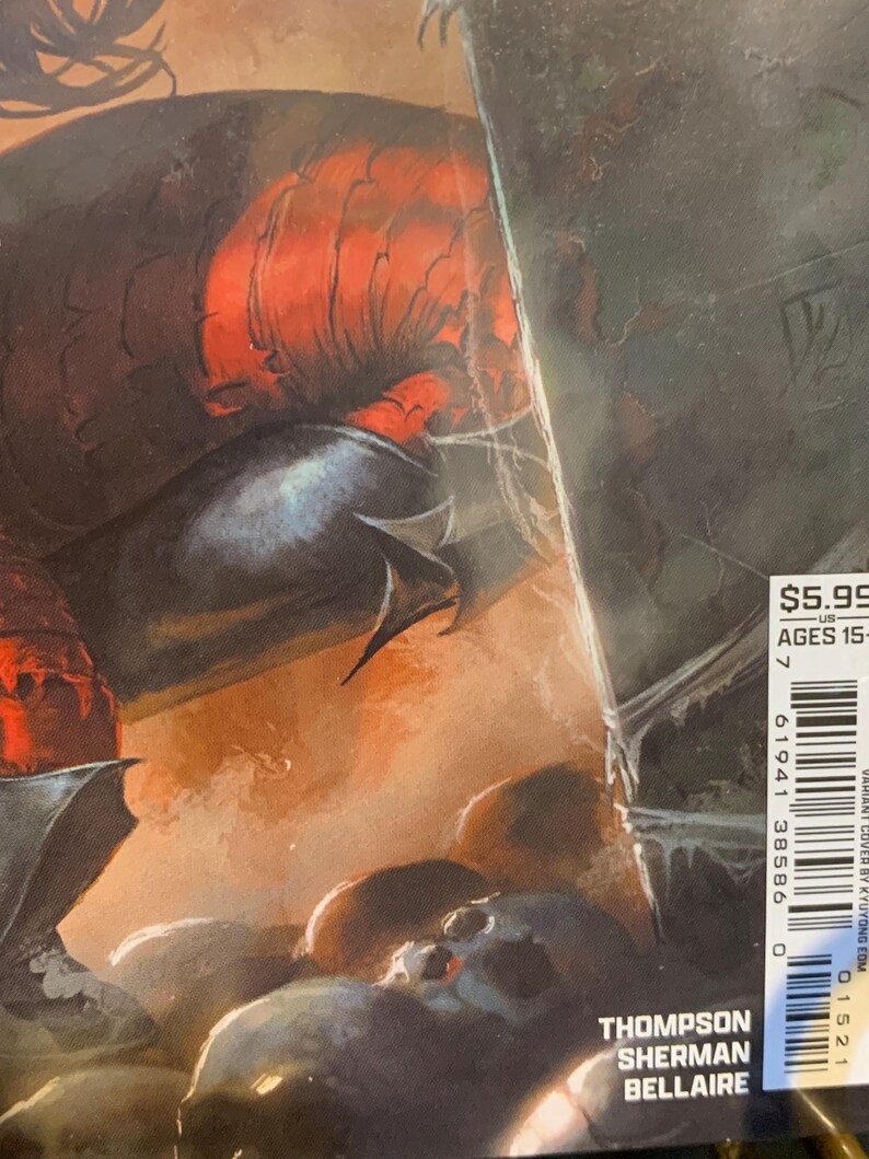 May include: Comic book cover featuring a dark, detailed illustration with a red and black color scheme. The artwork depicts a creature with sharp features and a skull. The cover includes the price, age range, and the names Thompson, Sherman, and Bellaire.