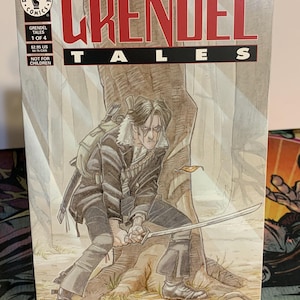 May include: A comic book cover featuring a man with a sword in a forest setting. The cover is for Grendel Tales #1 of 4, Devil's Choices. The comic book is published by Dark Horse Comics.