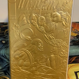 May include: A gold-colored comic book titled "Killer Instinct Chapter One" with embossed illustrations of muscular figures. The cover features the Image Comics logo and the number 6.