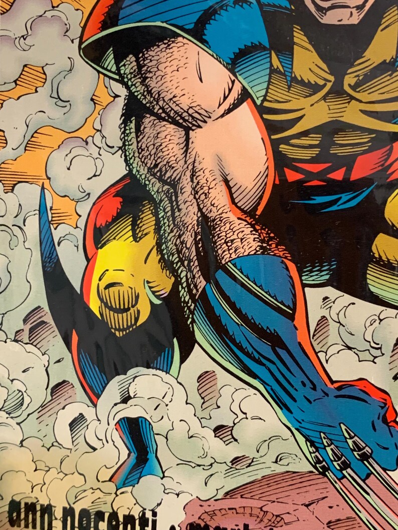 Pu&ograve; includere: Illustrazione di fumetti con un supereroe in azione. Il personaggio indossa un costume blu e giallo, con muscoli dettagliati e linee di azione. L'opera d'arte include il testo "ann nocenti".