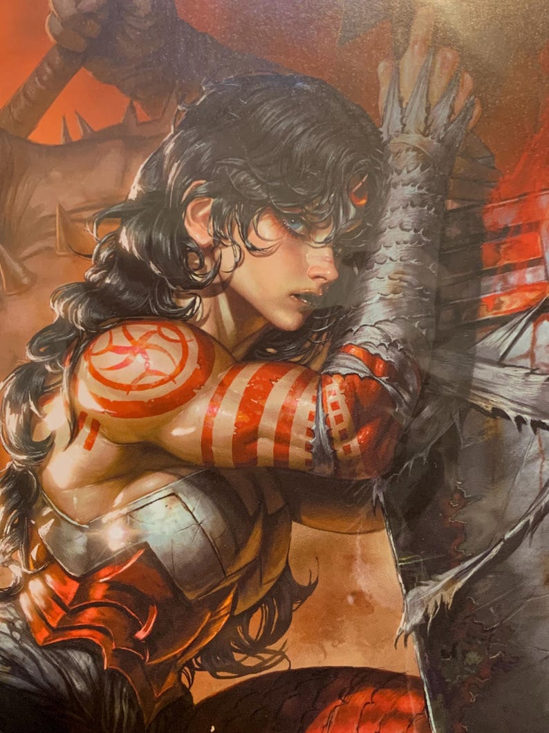 May include: Comic book illustration of a person with long dark hair and blue eyes, adorned with red and white markings on the arm and shoulder. The person is wearing red and silver armor, with a large, spiky, gray object in the background.