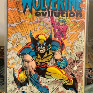 May include: A comic book cover featuring Wolverine in a dynamic pose, with a yellow and blue costume, claws extended. The title "Wolverine Evolution" is displayed in large, bold letters. The Marvel Comics logo is in the upper left corner.