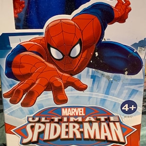 May include: A red and blue action figure of Spider-Man in a web-slinging pose. The packaging features the Marvel logo and the text "Ultimate Spider-Man". The box is labeled for ages 4 and up.