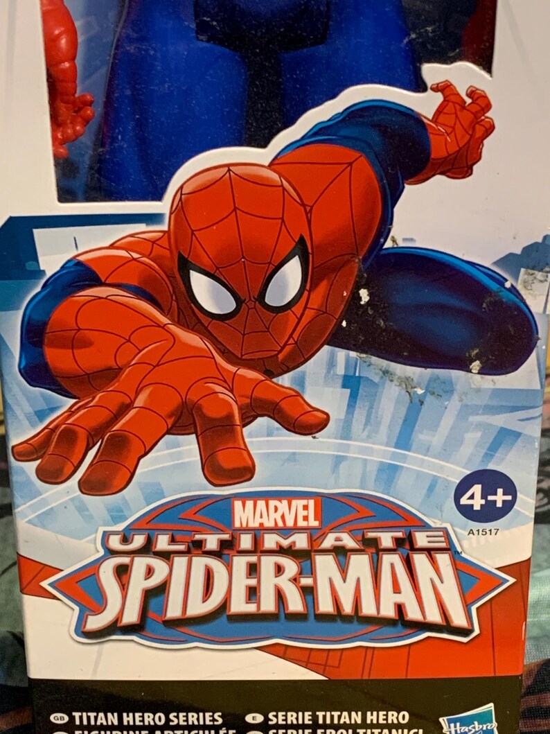 May include: A red and blue action figure of Spider-Man in a web-slinging pose. The packaging features the Marvel logo and the text "Ultimate Spider-Man". The box is labeled for ages 4 and up.