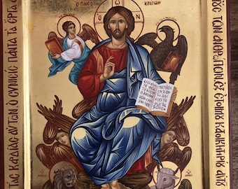 May include: A religious icon depicting Jesus Christ in a blue robe, seated on a throne with a golden background. He holds a book in his left hand and gestures with his right hand. The icon is surrounded by angels, a lion, a lamb, and a bird. The text on the icon reads "ἐξ ΧΡΟΝΟ ΕΠΕΒΛΕΤΕΝΟ ΚΥΡΙΟΣ ΕΙΔΕ πάτας MONAC ΤΑΣ ΚΑΔΙΑΣ AVTON, ὁ CVNICÍC NÓNΤΑ ΤΑ ΕΡΓΑ ΑΥΤΟΝ 10 Ο ΠΑΝΟ 0 N XC ΚΡΑΤΩΡ TẮC VƯỚC TÔN ΑΝΘΡΩΠON.ÈE ÉTOIMY KĀOIKHHPÍS AVTO ΕΠΕΒΛΕΨΕΝ де Спі пачтар на ΟΙΚΟ ΤΑΟ ΤΗΝ ΓΑΙ ΟΠΑΔΟΔΟ".