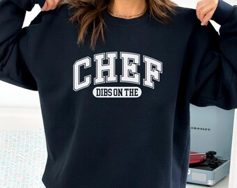 May include: A black sweatshirt with white text that reads "CHEF DIBS ON THE".