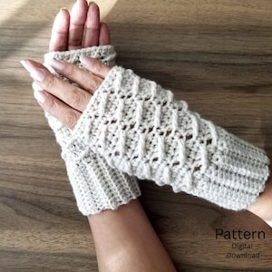 May include: A pair of cream-colored fingerless gloves featuring a textured crochet pattern with vertical ribbed cuffs at the wrists. The gloves have an open design that leaves the fingers exposed. The text Pattern Digital Download is visible.
