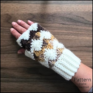 May include: A fingerless glove featuring a crochet granny square pattern in shades of cream, tan, and dark brown. The accessory includes a ribbed cuff at the wrist and a textured starburst design throughout the main body. Text reads Pattern Digital Download.
