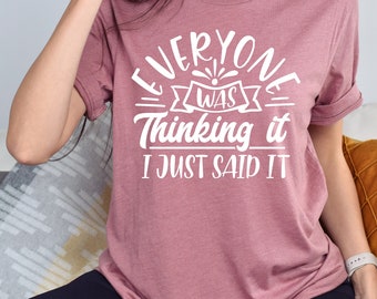 May include: A mauve t-shirt with the text "Everyone was thinking it I just said it" in white.