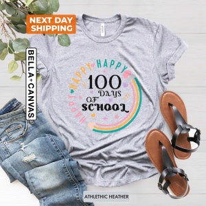 May include: Grey t-shirt with a colourful rainbow design and the text "Happy 100 Days of School".