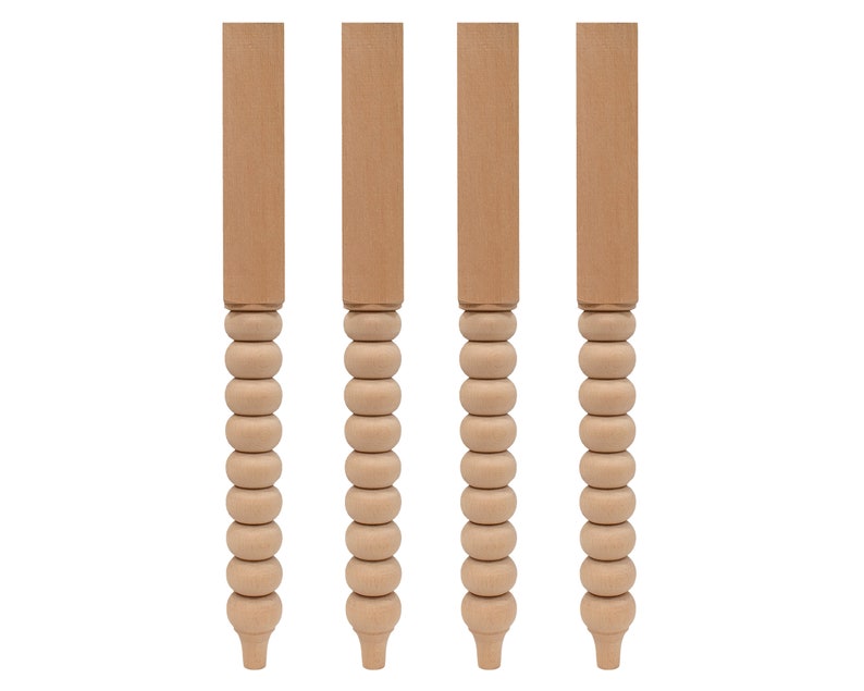May include: Four unfinished wooden table legs with a beaded design. Each leg is about 16 inches tall.