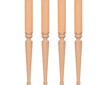 May include: Four unfinished wooden table legs with a turned design. The legs are approximately 18 inches long.