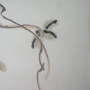 May include: A minimalist ink wash painting on off-white paper featuring fluid, thin black and brown lines that form abstract, organic shapes. The composition includes delicate brushstrokes and soft, muted brown ink splatters across the surface.