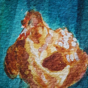 May include: Abstract watercolour painting with a central, textured form in brown, orange, and yellow, accented with white. The background blends teal and blue, creating a vibrant artistic composition. The artwork has a textured appearance.