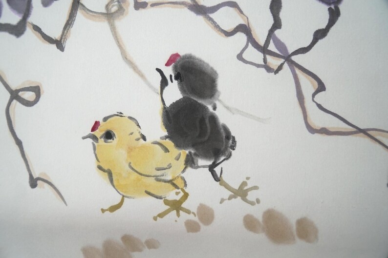 May include: An ink and watercolor painting on paper featuring a yellow chick and a black chick standing together. The yellow chick has a small red crest, and the black chick is positioned behind it. Thin, dark, flowing lines suggest branches above.