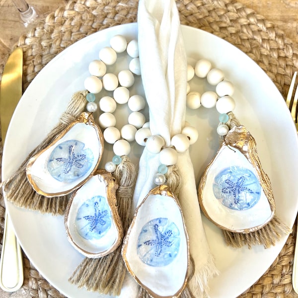 Bridal shower decor idea coastal table setting shell napkin ring for coastal beachy bridal shower Hamptons Nantucket style decor sand dollar