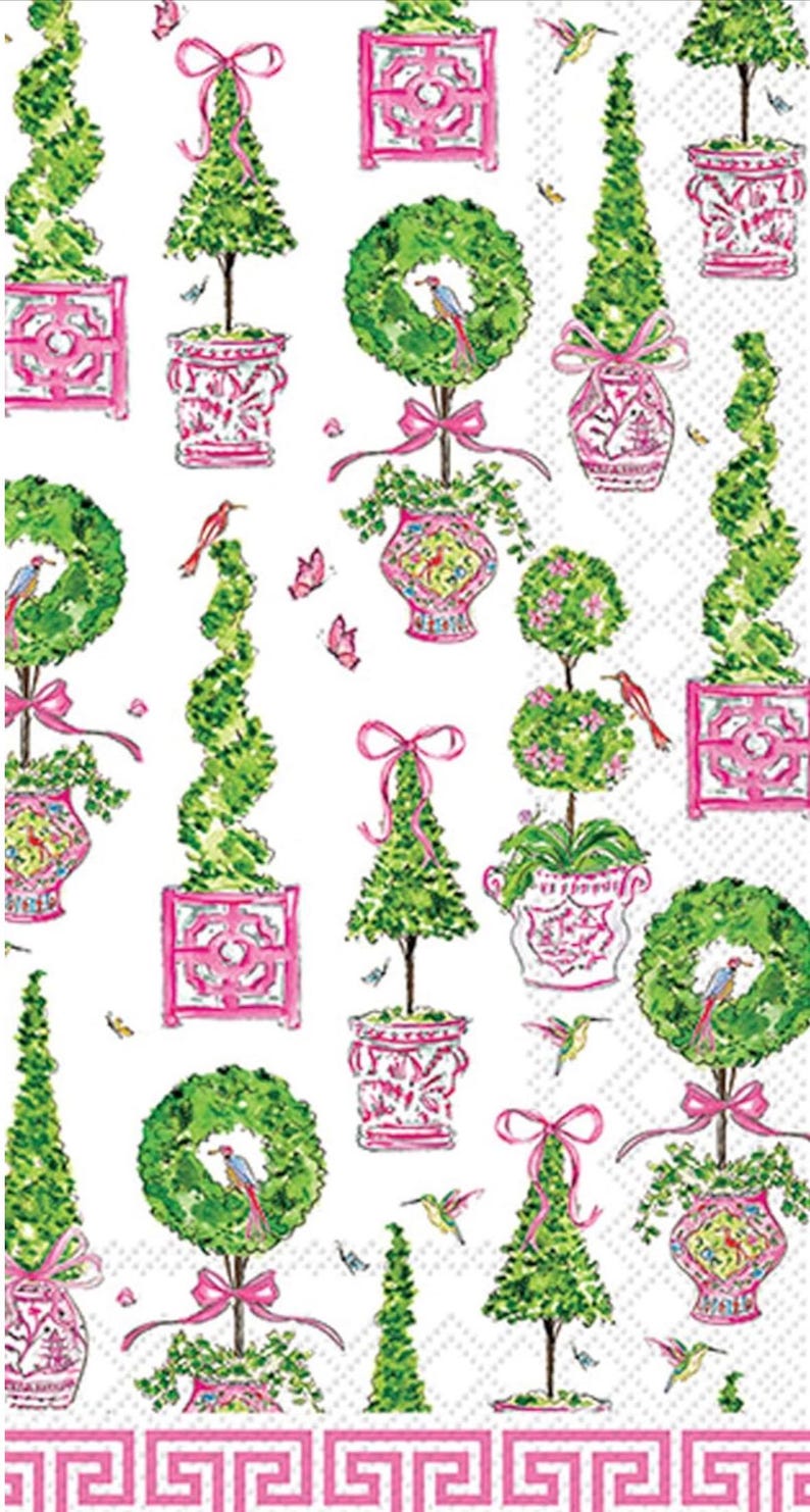 May include: A white background with a repeating pattern of green topiary trees, wreaths, and decorative pots in pink. The design includes pink bows, butterflies, and birds. A pink Greek key border frames the bottom.