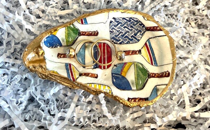 multicolor pickleball paddle design on an oyster shell ring dish