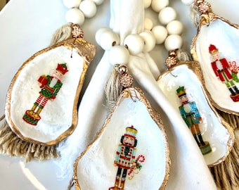 Nutcracker oyster shell napkin ring. Christmas oyster shell napkin ring set. Beachy Christmas decor. Coastal Christmas table setting idea
