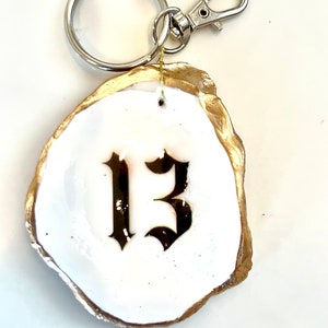Thirteen keychain Swiftie gift idea. Swiftie gift decoupaged oyster key chain. Swiftie party favor idea. Taylor Eras favor keychain favor