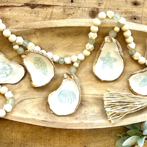 Coastal home decor sea glass  mantel beachy tree garland shell art. Ocean oyster shell garland nautical decor for coastal home & lake home
