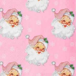 May include: Pink background with a repeating pattern of vintage Santa Claus faces. Each Santa has a pink hat, white beard, and a smiling face. Small white snowflakes are scattered across the background.
