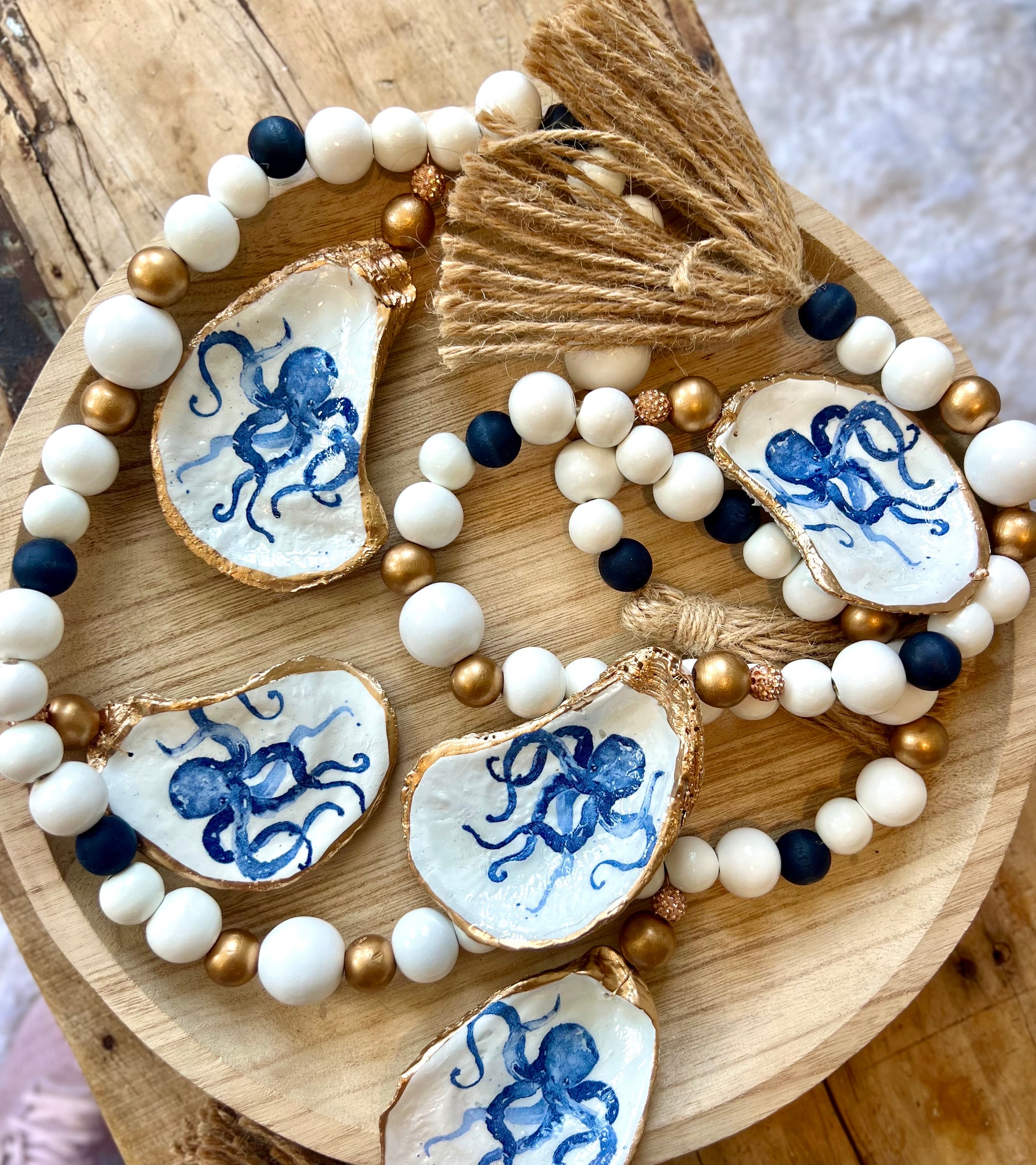 Coastal boy baby shower shell garland centerpiece & oyster napkin ring decor set. Decoupaged oyster shell beachy baby shower decor idea