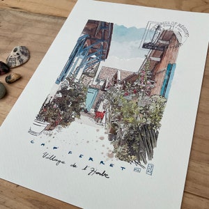 May include: Watercolor painting of a village street scene in Cap Ferret, France. The artwork features buildings with blue shutters and wooden beams, lush greenery, and the text "Cap Ferret Village de l'Herbe". A postage stamp is visible in the upper right corner.