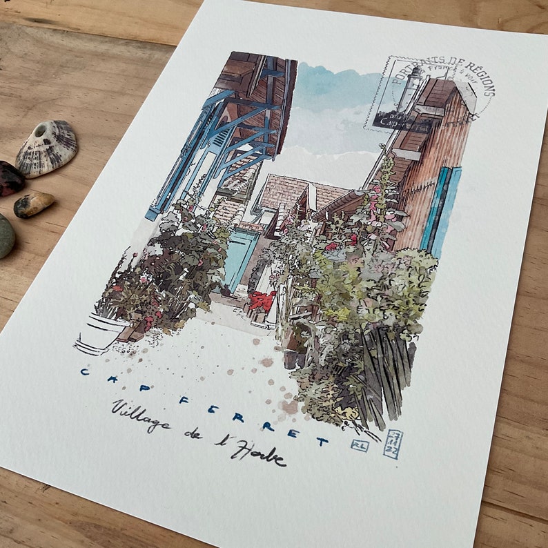 May include: Watercolor painting of a village street scene in Cap Ferret, France. The artwork features buildings with blue shutters and wooden beams, lush greenery, and the text "Cap Ferret Village de l'Herbe". A postage stamp is visible in the upper right corner.