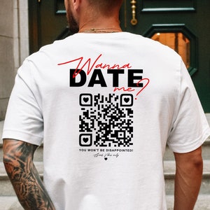 May include: White t-shirt with a black and white QR code and the text "Wanna Date Me?" in red and black. The text "You won't be disappointed!" is also printed on the shirt.