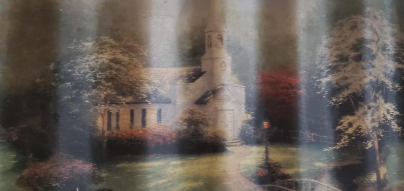 May include: A painting of a church with a steeple, surrounded by trees and greenery. The artwork features a pathway leading to the church, with a soft, muted color palette. The scene evokes a sense of tranquility and nostalgia.