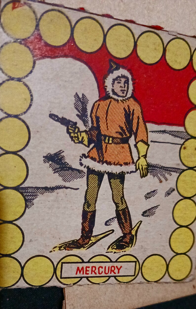 May include: A vintage illustration of a cartoon character wearing a fur-trimmed coat and holding a gun. The character is standing on a snowy landscape. The image is surrounded by a border of yellow circles. The text "MERCURY" is printed below the character.