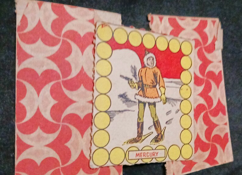 May include: A vintage game card featuring a cartoon illustration of a person wearing a fur-trimmed coat and snowshoes. The card has a yellow border with a red background and the word "MERCURY" printed at the bottom.