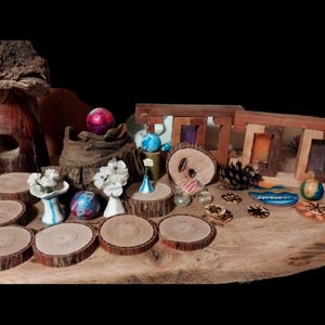 May include: A collection of decorative items, including wooden coasters, small vases, and miniature wooden frames, arranged on a large wooden slab. The items feature various colors and textures, creating a rustic and artistic display.