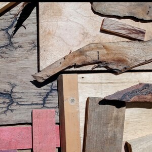 May include: A collection of wood pieces with different textures and colors. Some pieces have a natural wood finish, while others have been stained or painted. The wood pieces are arranged in a random pattern, creating a unique and interesting design.