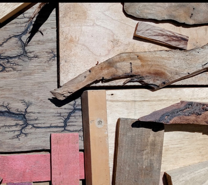 May include: A collection of wood pieces with different textures and colors. Some pieces have a natural wood finish, while others have been stained or painted. The wood pieces are arranged in a random pattern, creating a unique and interesting design.