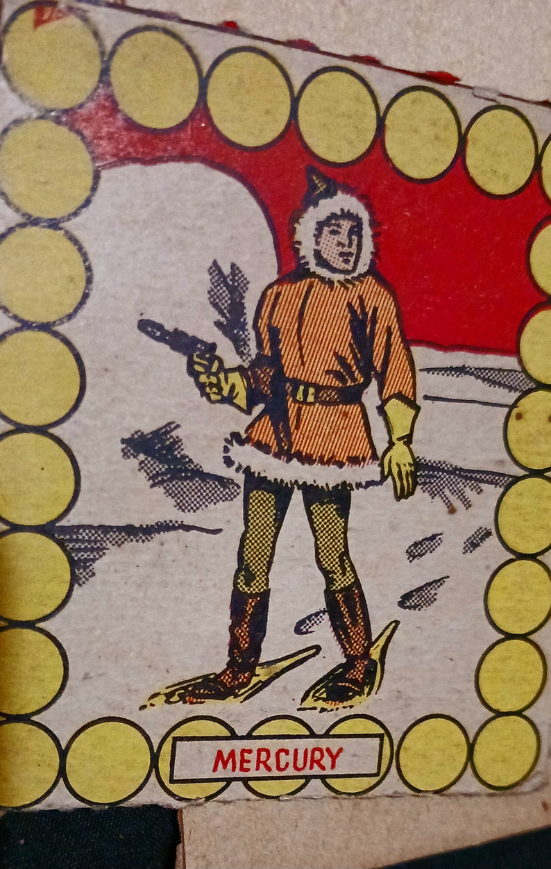 May include: A vintage illustration of a cartoon character wearing a fur-trimmed coat and holding a gun. The character is standing on a snowy landscape. The image is surrounded by a border of yellow circles. The text "MERCURY" is printed below the character.