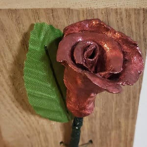 Mother's Day or any day Gift for her clay Rose on Wooden background. Bronze