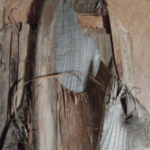May include: Close-up of weathered wood pieces with varying shades of brown, gray, and tan. The wood has a rough, textured surface with visible cracks and splinters. Some pieces have a silvery-gray hue, while others are a warm brown.